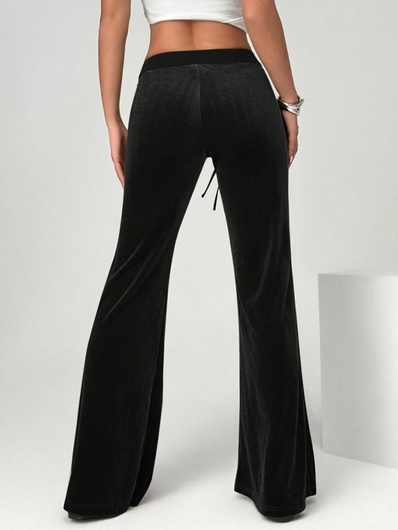 Black wide-leg pants worn by a person on a white background