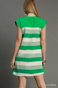 Green and white striped dress on a model against a gray background