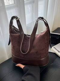 Brown handbag on a chair with a blurred background