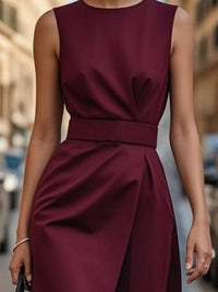 Burgundy dress worn by a person on a blurred city street background
