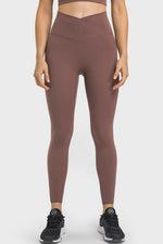 Person wearing brown leggings on a white background