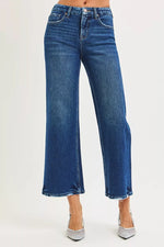 Blue jeans worn by a person on a white background