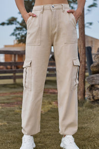 Person wearing beige cargo pants with a blurred outdoor background