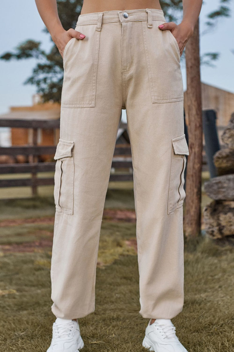 Person wearing beige cargo pants with a blurred outdoor background