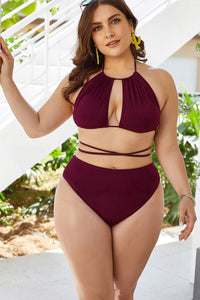 Woman wearing a burgundy bikini set with a white background