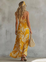 Woman wearing a yellow floral dress against a gray wall