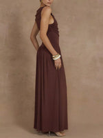 Woman wearing a brown halter neck dress against a beige background