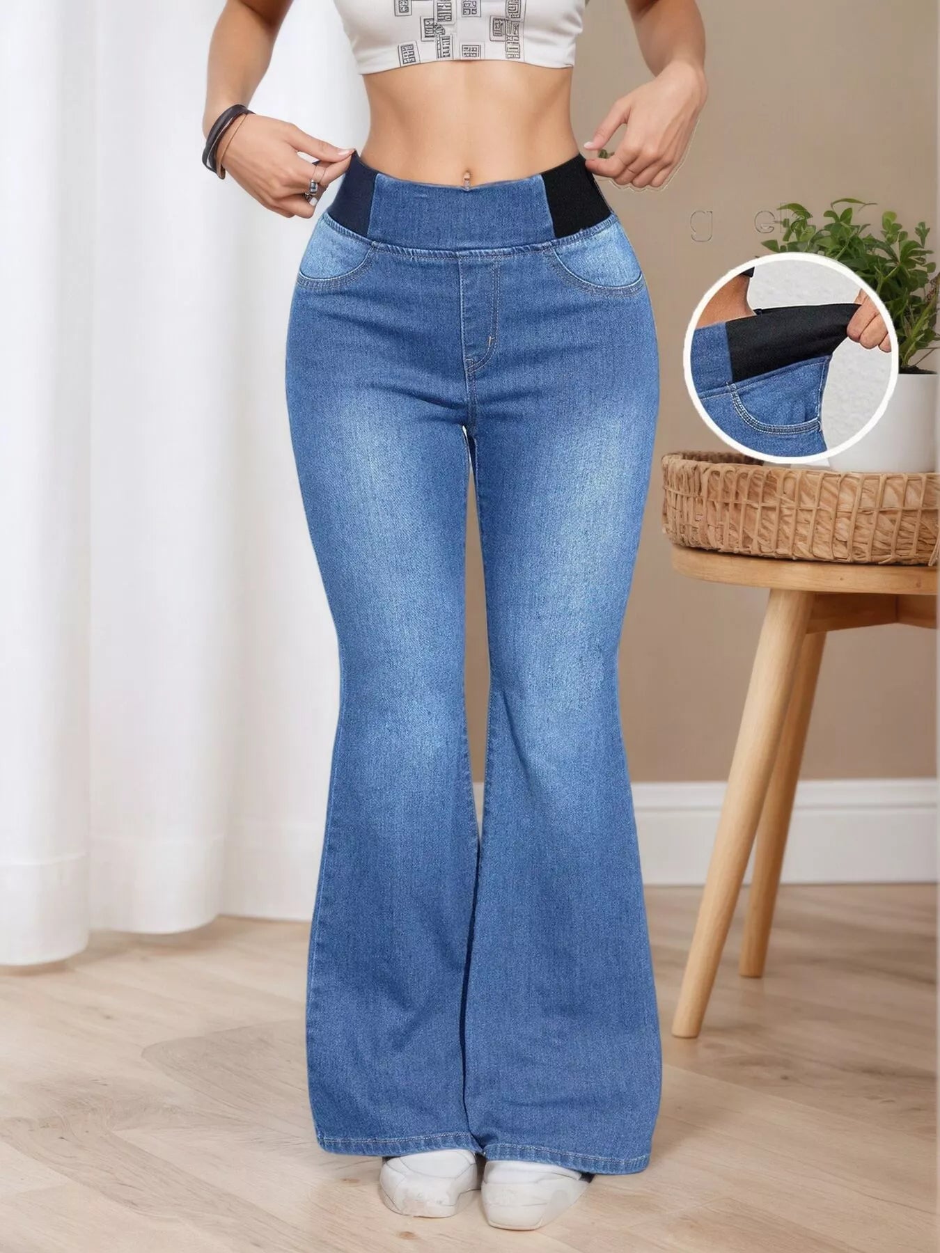 Woman wearing blue flared jeans with a close-up inset showing the waistband.