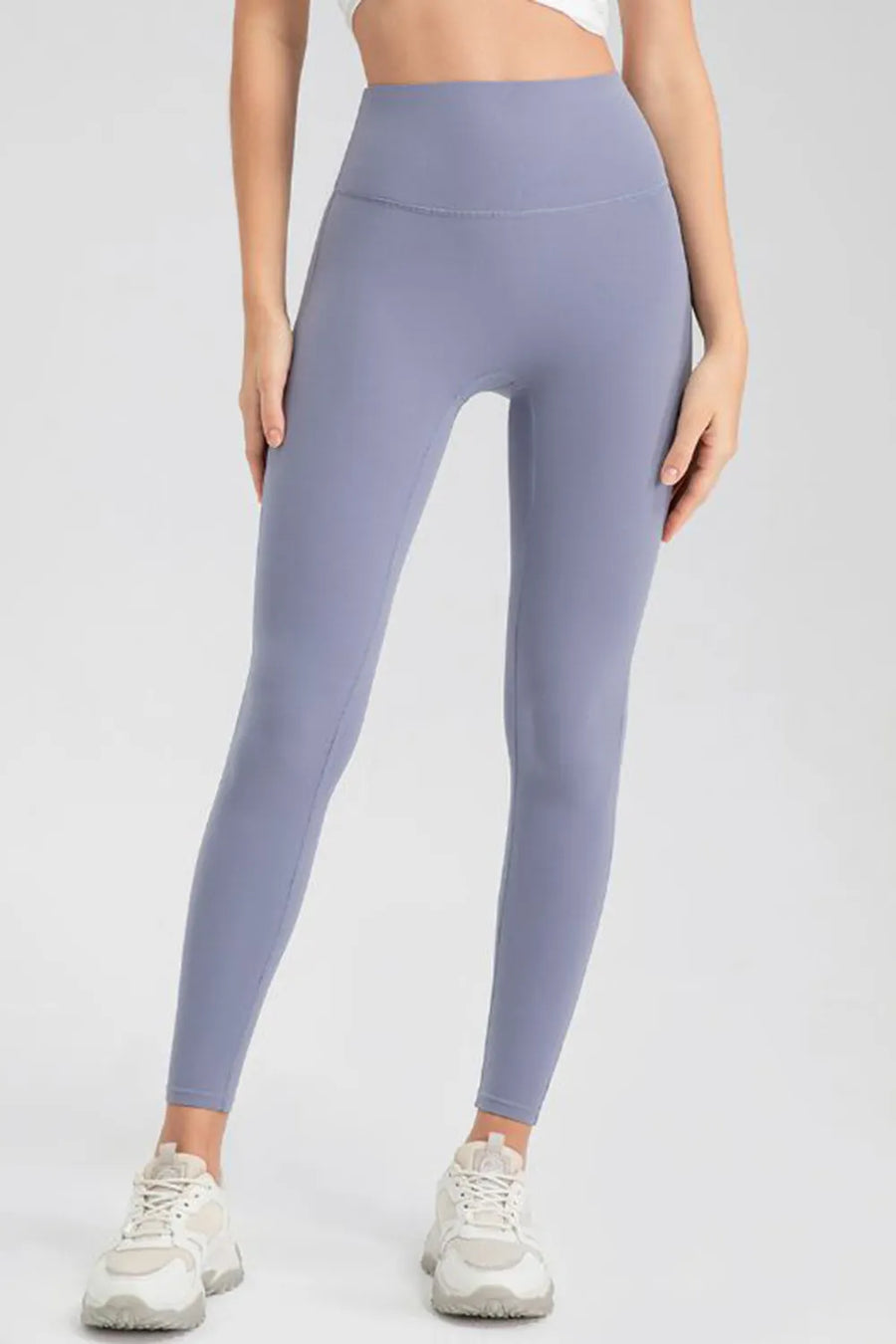 Person wearing light purple leggings on a white background
