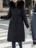 Lady on the outside of a building wearing a black Women's Detachable Longline Hooded Parka with Faux Fur Trim and Drawstring Waist