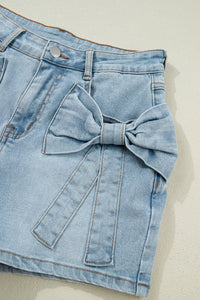 Denim skirt with a large bow detail on a light background