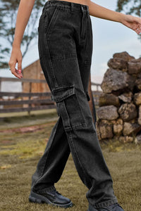 Person wearing black cargo pants standing outdoors with a rustic background