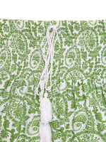 Green and white patterned fabric with a string tied through it