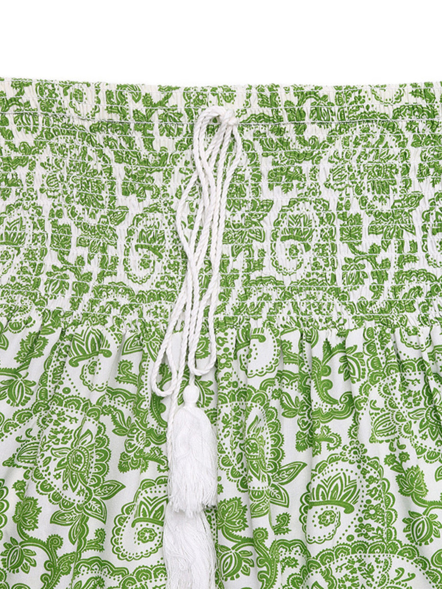 Green and white patterned fabric with a string tied through it