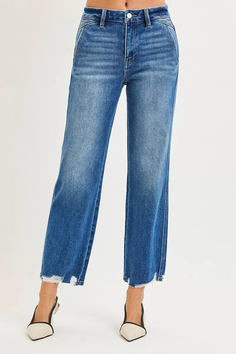 Blue jeans worn by a person on a white background