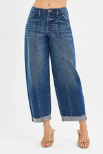 Blue jeans worn by a person on a white background