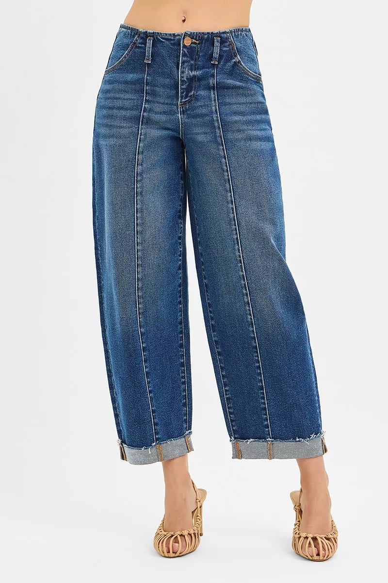 Blue jeans worn by a person on a white background
