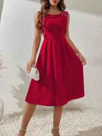 Red dress with floral details on shoulders against a white background