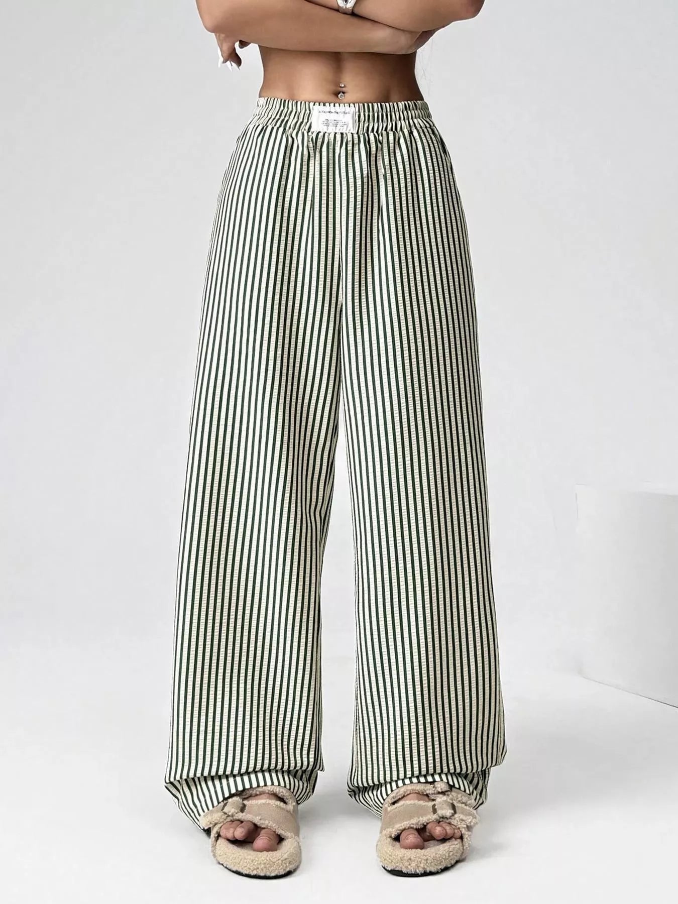 Striped wide-leg pants worn by a person on a white background