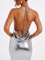Silver metallic dress with open back on a white background