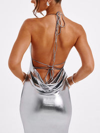 Silver metallic dress with open back on a white background
