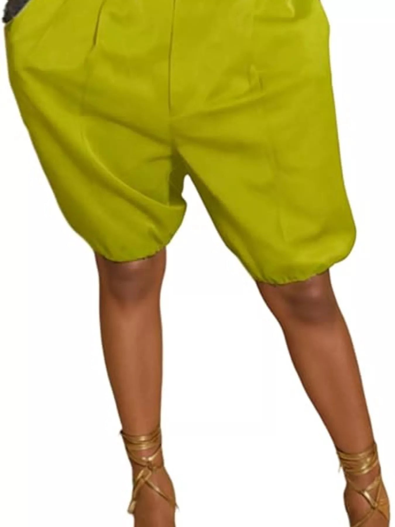 Green shorts worn by a person on a white background