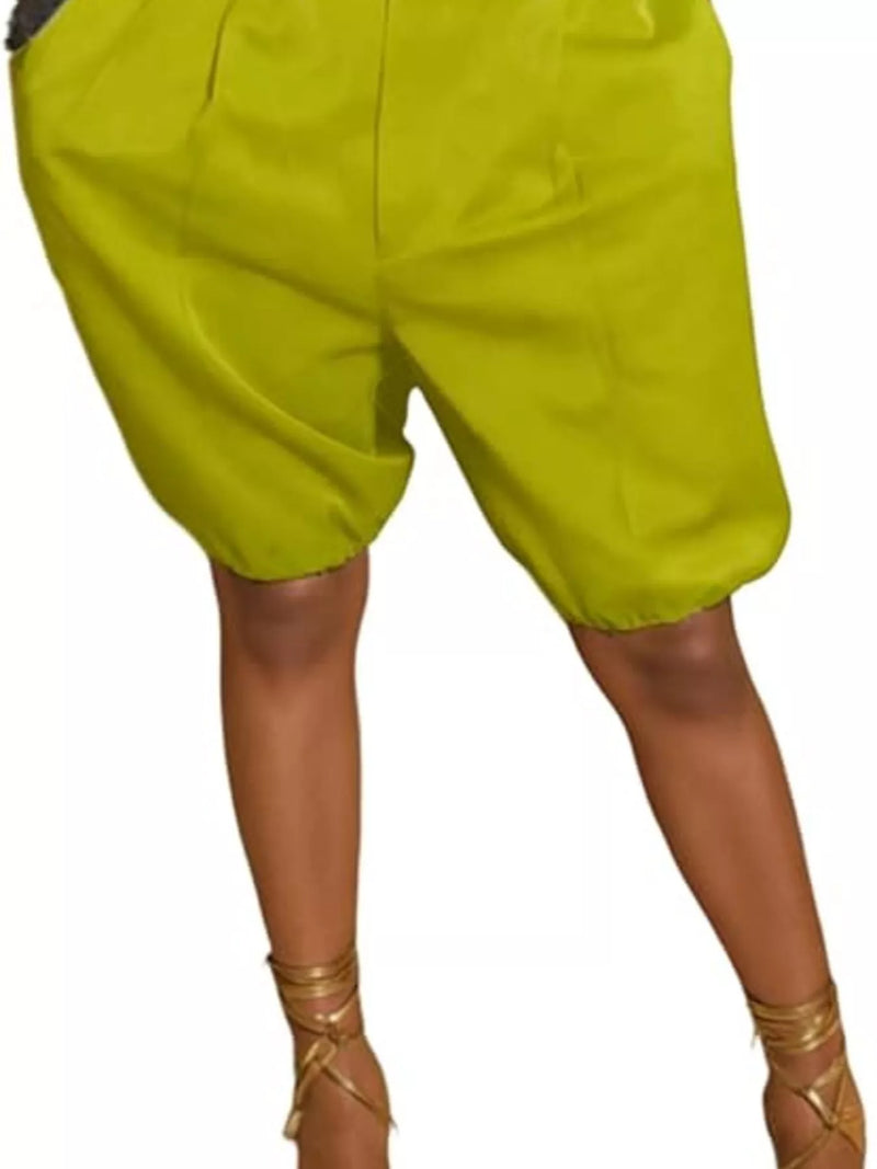 Green shorts worn by a person on a white background