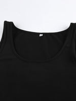 Close-up of a black tank top with a brand label on a white background