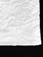 Close-up of textured white paper with black border