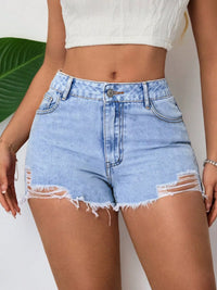 Light blue denim shorts with frayed edges worn by a person on a neutral background