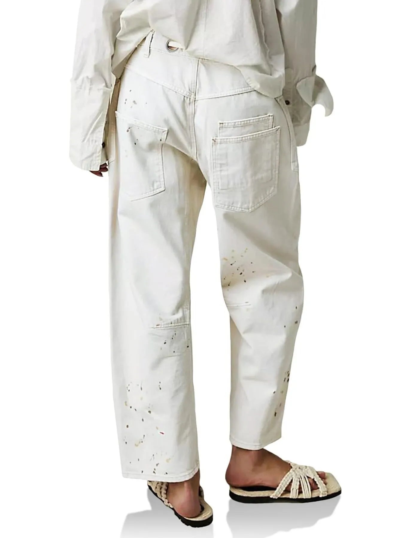 White pants with subtle pattern worn by a person on a white background