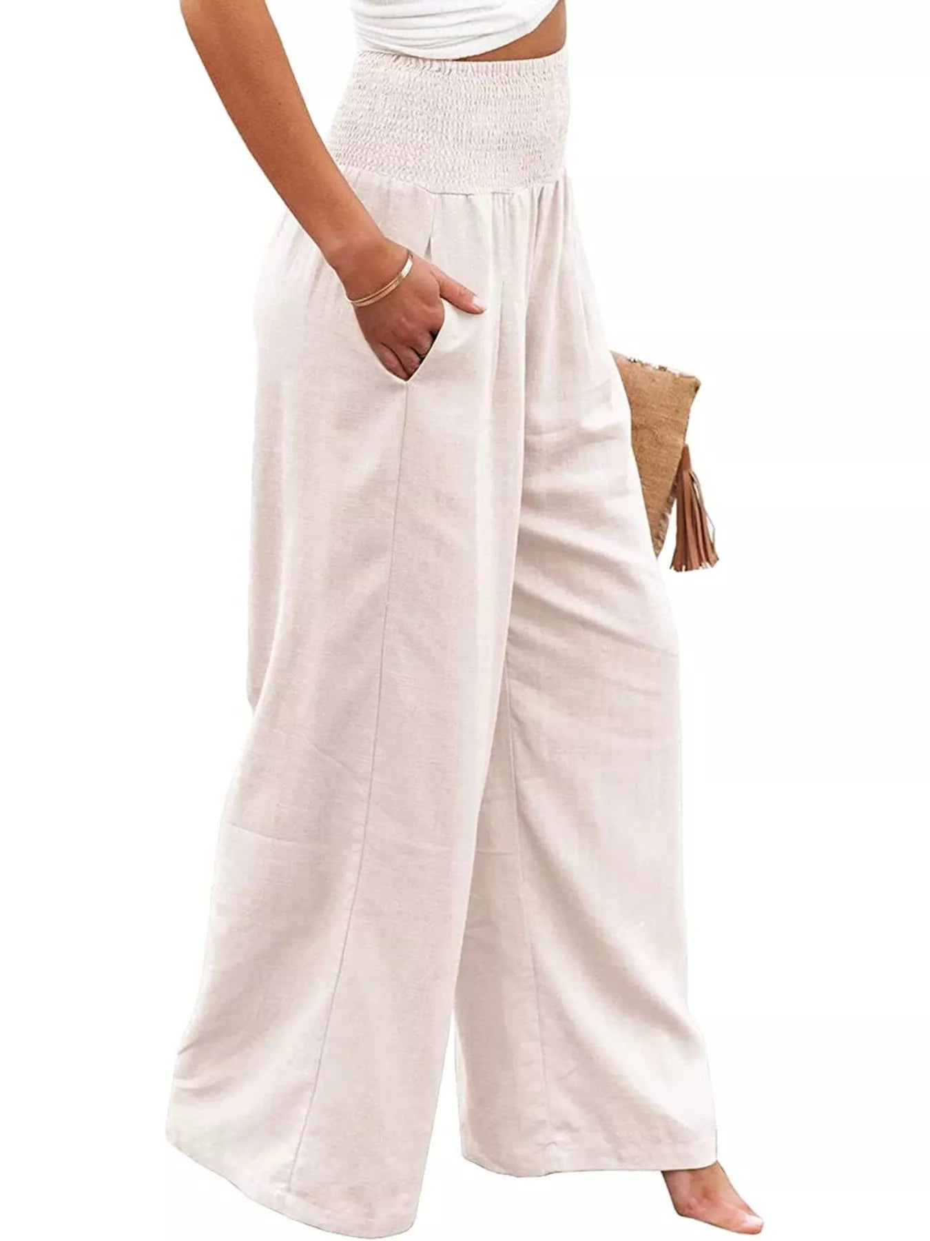 Person wearing white wide-leg pants on a white background