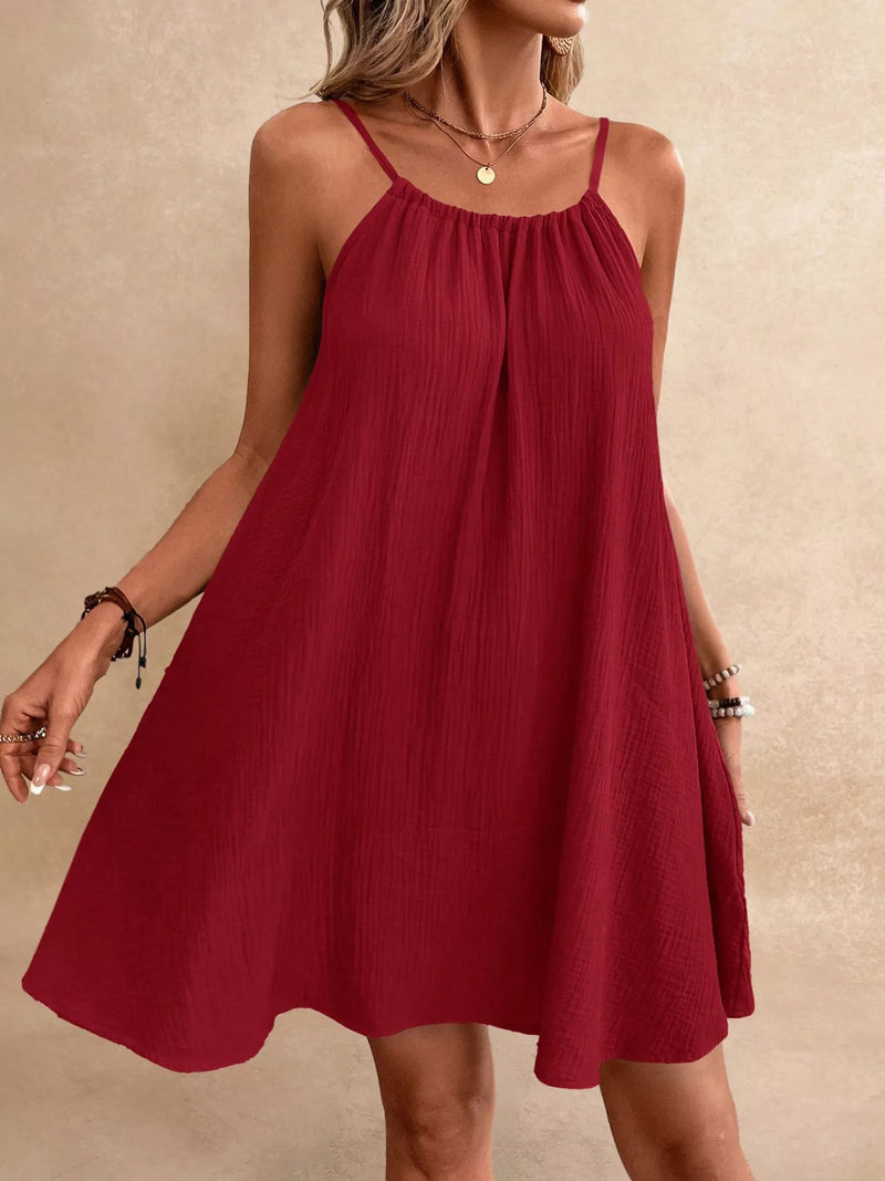 Red dress worn by a person on a beige background