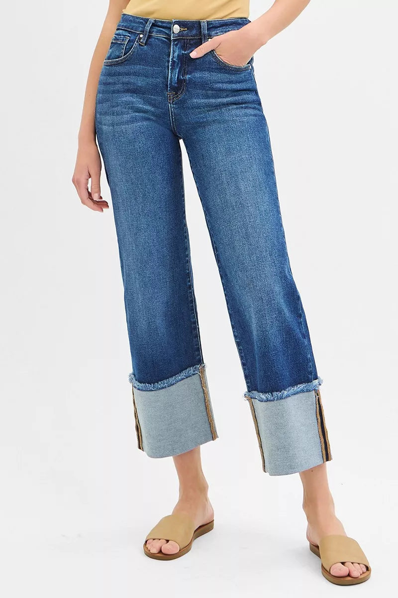 Person wearing blue jeans with a white background