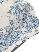 Blue and white toile pattern on a fabric swatch