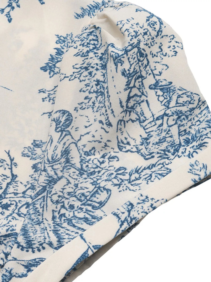 Blue and white toile pattern on a fabric swatch