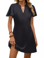 Black dress worn by a model on a white background