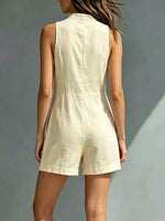 Woman wearing a beige romper against a neutral background