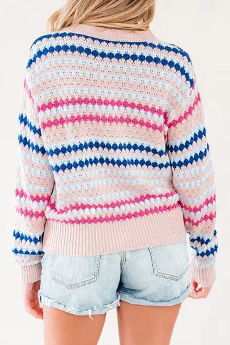 A woman shown from the back wearing a pastel striped crochet sweater with pink, blue, and white horizontal stripes, paired with light-wash denim shorts.