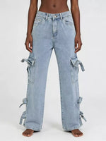 Light blue jeans with tie details on a white background