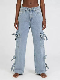 Light blue jeans with tie details on a white background