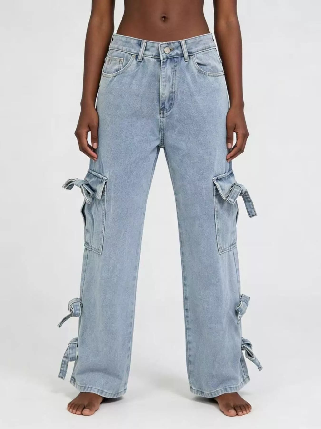 Light blue jeans with tie details on a white background