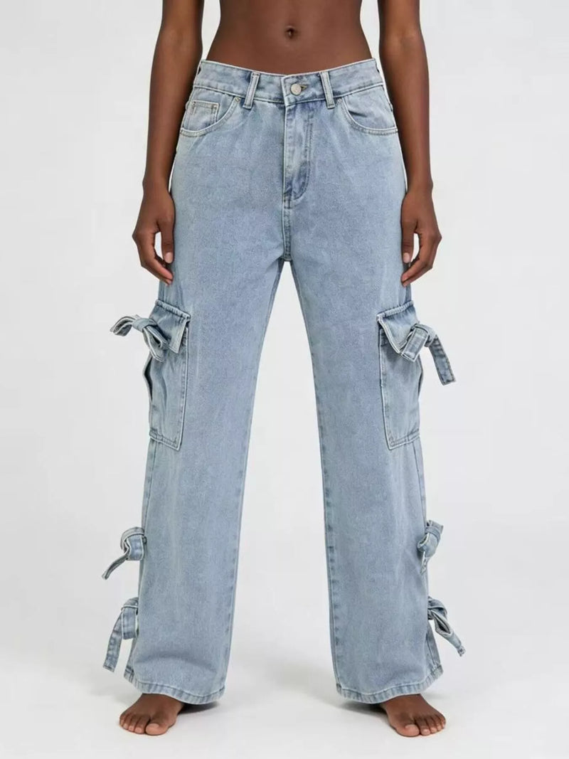 Light blue jeans with tie details on a white background