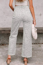 Person wearing light green patterned pants with a neutral background