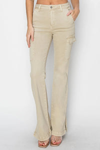 Beige flared jeans worn by a person on a white background