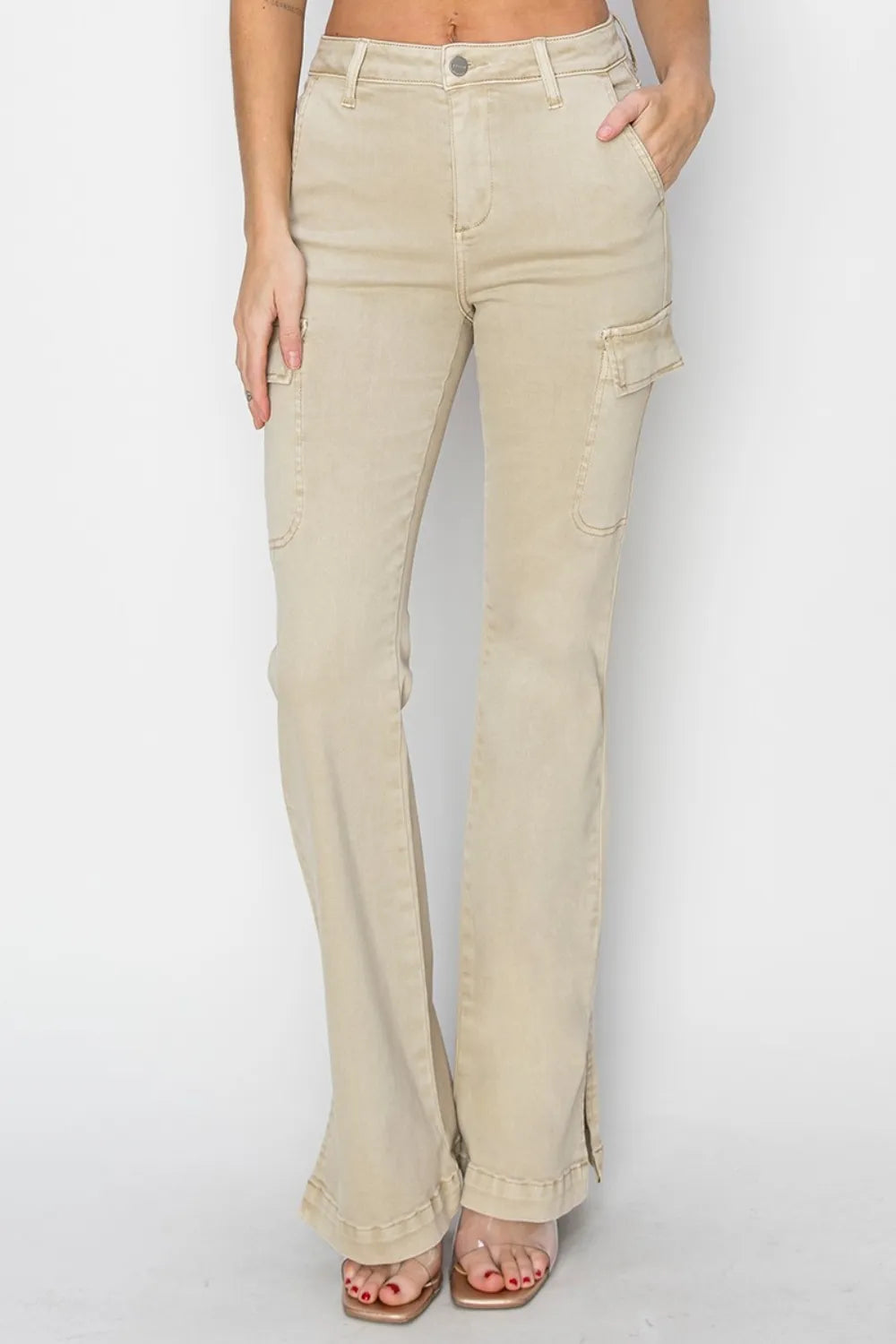 Beige flared jeans worn by a person on a white background