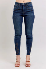 Blue jeans worn by a person on a light gray background