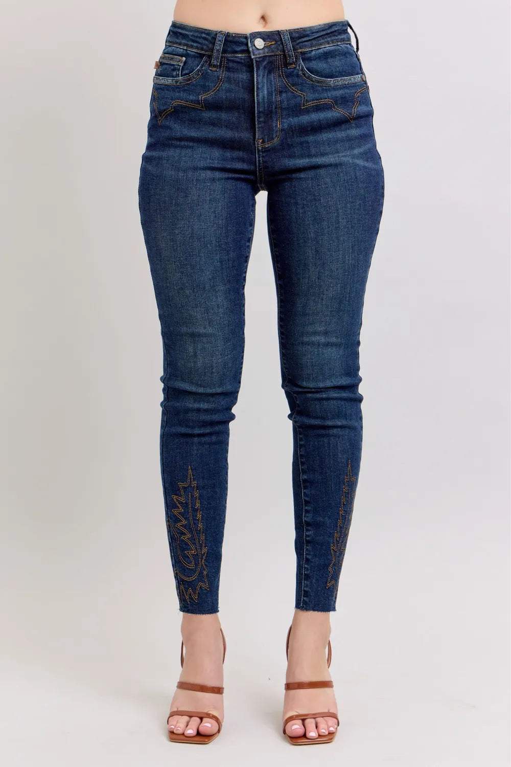 Blue jeans worn by a person on a light gray background