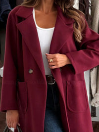 Maroon coat worn by a person with a blurred background