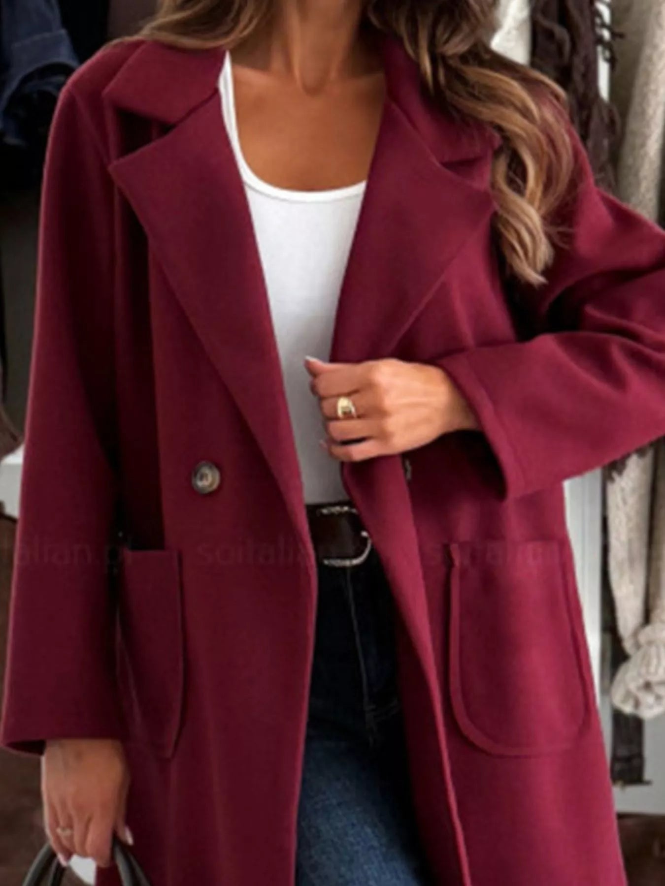 Maroon coat worn by a person with a blurred background